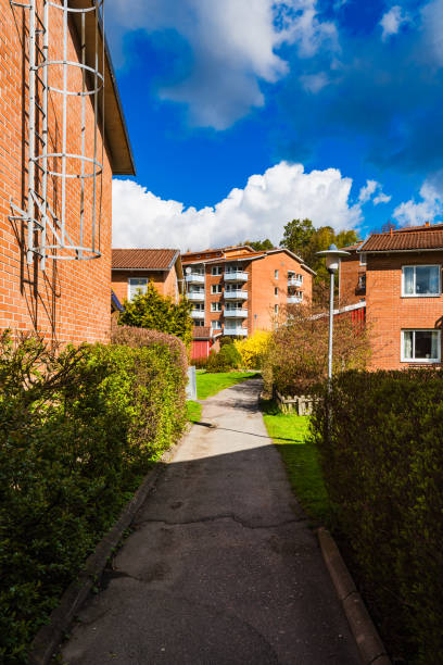 istock Charming residential pathway in Sweden surrounded by greenery and apartments on a sunny day 2203248698