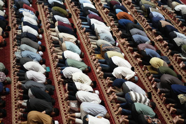 Man Prays For Ramadan On Carpet During Sunny Day.