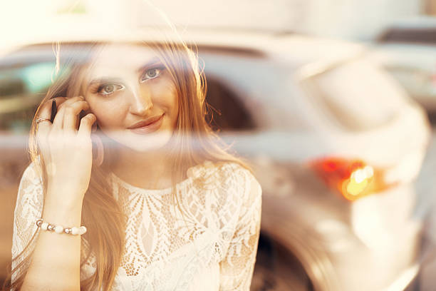 Attractive young woman daydreaming and looking through the window