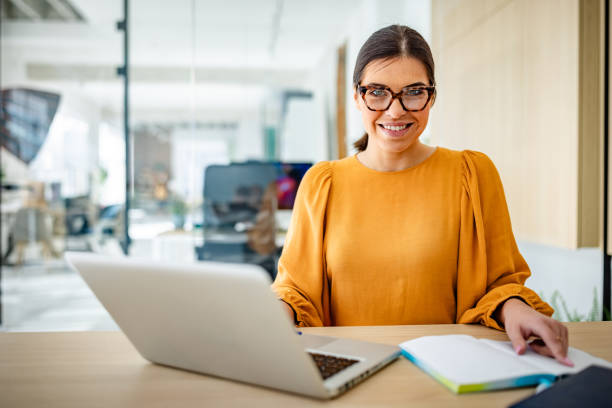 istock Young businesswoman engaged in work at modern office promoting teamwork and cooperation 2203251896