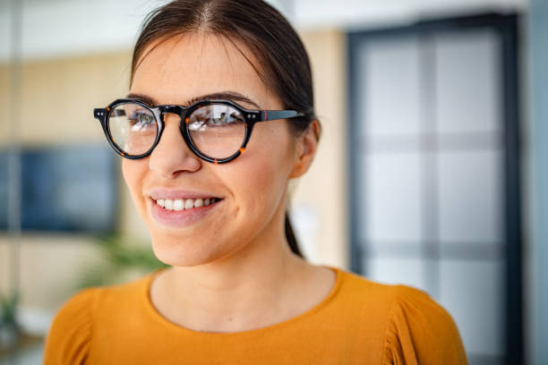 istock Young businesswoman smiling confidently while engaging with colleagues in a modern office environment 2203252082