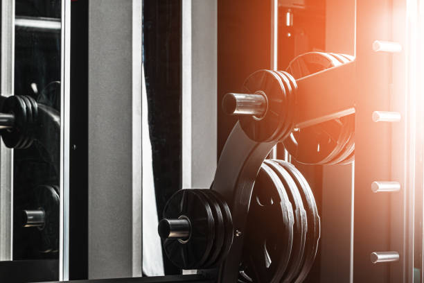 Young woman engaging with a leg press machine during an intense fitness workout in a modern gym environment, showcasing her dedication