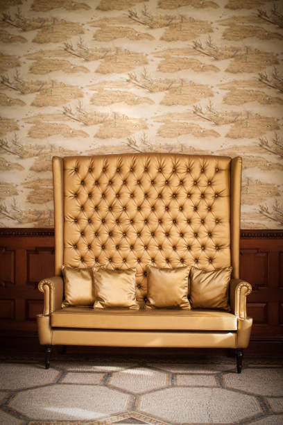 High-back gold sofa with cushions, Scotland