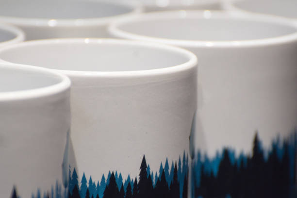 Set of ceramic white cups for tea or coffee. Handmade mugs for souvenirs.