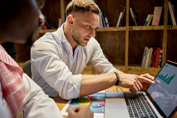 istock Diverse business team looking at data on laptop 2203254252