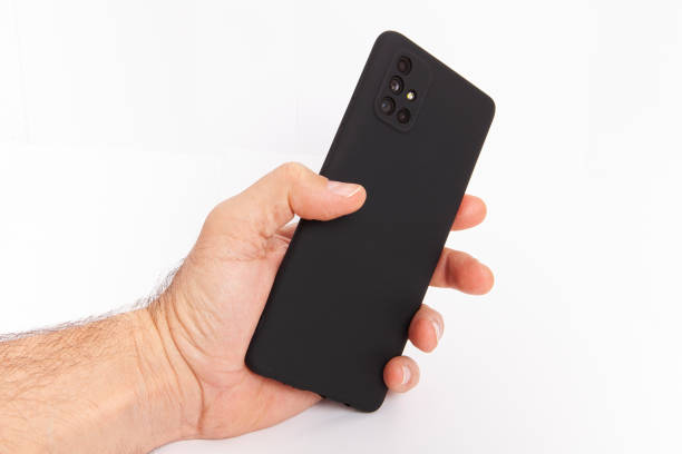 istock Mobile phone on white background. Hand holding mobile phone on white background. 2203254853