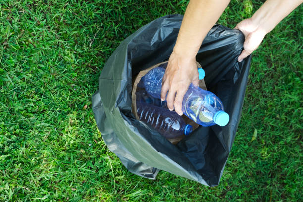 istock hand holding garbage bottle plastic putting into recycle bag for cleaning 2203255611