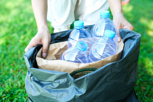 istock hand holding garbage bottle plastic putting into recycle bag for cleaning 2203255728