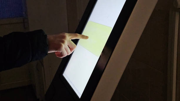 istock A person uses a digital touch screen display, touching a highlighted area concept 2203256254