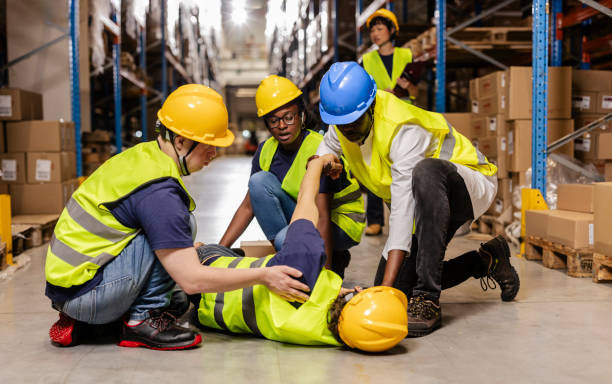 istock Warehouse workers helping injured colleague after accident 2203257782