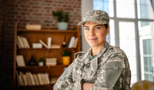 istock Young woman in military uniform confidently working from home in a cozy office setting 2203257943