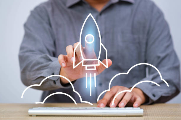 istock Businessman interacting with virtual rocket startup hologram on a digital interface. Innovation and technology concept for new business ventures. 2203257958