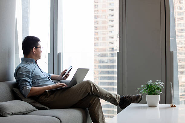 istock asian businessman using smart phone and laptop in office 2203258488