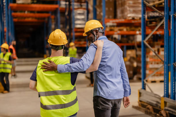 istock Manager and worker walking together in warehouse, showing teamwork 2203258512