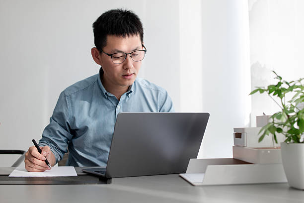 istock asian businessman working on laptop in office 2203258572