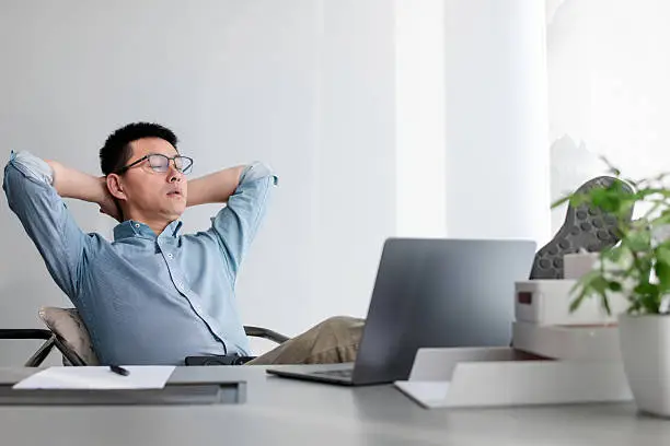 asian businessman working on laptop in office asian businessman working on laptop in office