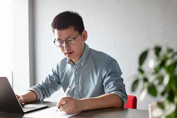 istock asian businessman working on laptop in office 2203258677