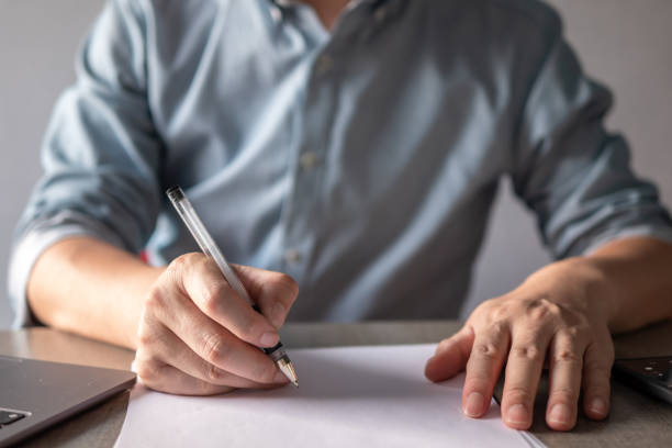 istock asian businessman writing on white paper 2203258715