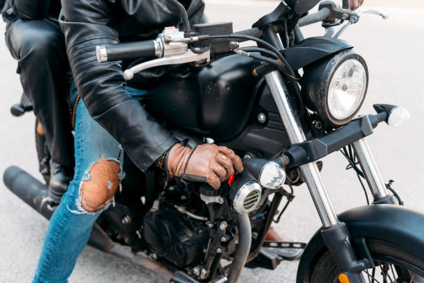istock Biker wearing leather jacket and gloves is starting motorcycle 2203259551