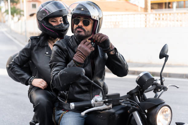 istock Bikers couple wearing helmet and leather jacket riding motorcycle 2203259564