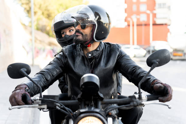 istock Bikers couple riding motorcycle wearing leather jackets and helmets 2203259571