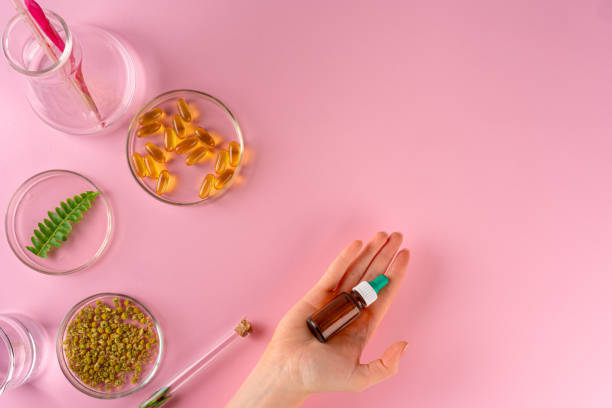 istock Herbs and Herbal dietary supplements top view on pink background 2203259859
