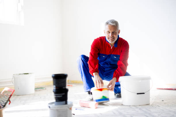 Professional house painter preparing colors to paint walls in the apartment