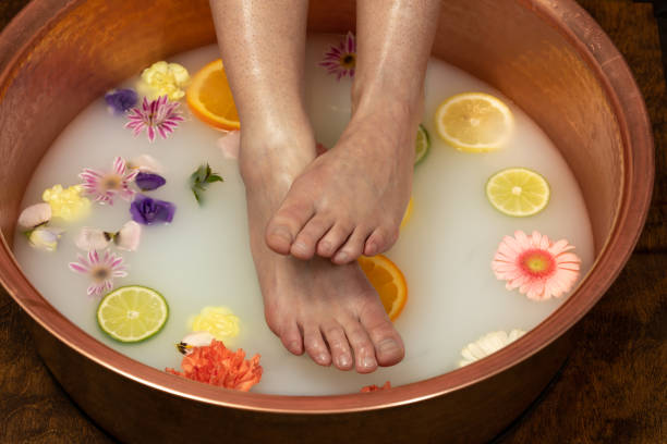 istock Female feet and ankles soaking in a milk bath 2203261444