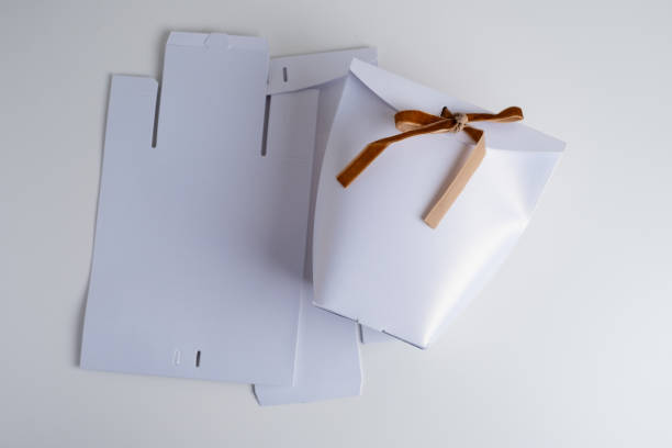 istock White cardboard box mockup with velvet ribbon for design presentation. Packaging template for perfume, branded product, beauty industry advertising, pharmacy, gifts. Place for label 2203263576
