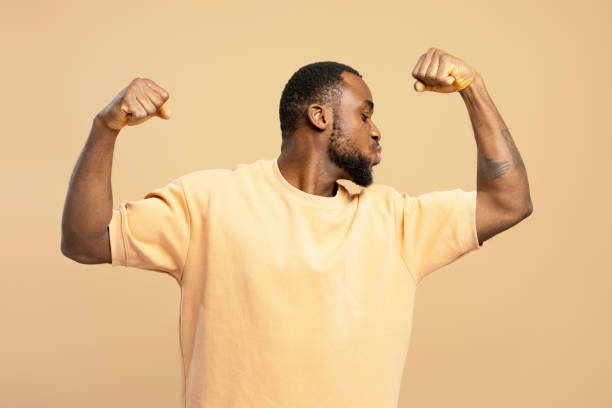 istock Young man flexing biceps and kissing them 2203263605