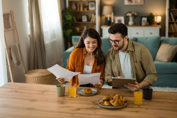 istock Couple manages expenses and bills at home 2203263657