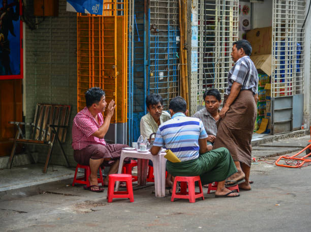 Yangon, Myanmar - Feb 1, 2017. Burmese men drinking coffee on street in Yangon, Myanmar.