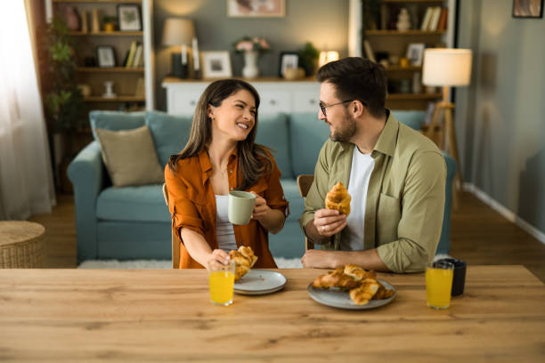 istock Couple eating breakfast together and talking at home 2203264867