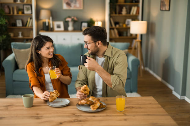 istock Couple eating breakfast together and talking at home 2203264903