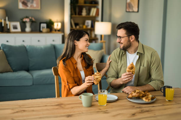 istock Couple eating breakfast together and talking at home 2203264986