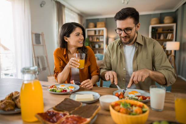 istock Couple eating lunch together and talking at home 2203265682