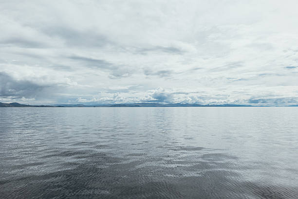 Tranquil seascape under cloudy sky. Vast ocean stretching to distant horizon. Calming natural scene for peaceful or meditative themes.
