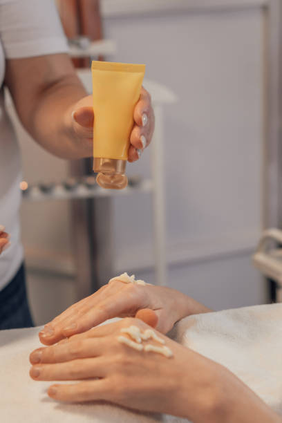 istock Applying Hand Cream Skincare Treatment in a Spa 2203266533