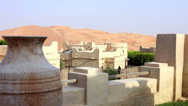 istock Stunning heritage building oriental style architecture surrounded by desert sand. Decorative wall-mounted vase and intricate design elements highlight elegance historical significance of structure 2203266640