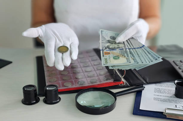 istock Coin and currency collection activity featuring expert handling and examination in a well-lit workspace concept 2203267302