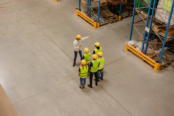 istock Warehouse manager instructing workers during a meeting in a distribution center 2203268431