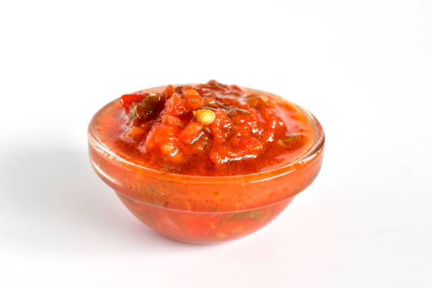 Seasoning for meat dishes. Spicy adjika consisting of chili peppers and tomatoes.