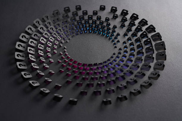 istock Intricate cut paper artwork with circular pattern of question mark cutouts on black paper revealing color gradients 2203269300