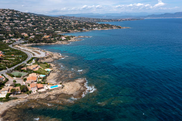 Aerial view of a French Riviera, Cote d'Azur coast with beaches, hotels, restaurants, villas and blue Mediterranean Sea.