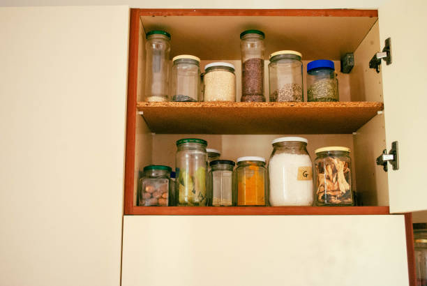 Kitchen jars on a shelf with Macaroni, Sugar, Spaghetti, Flour and Rice