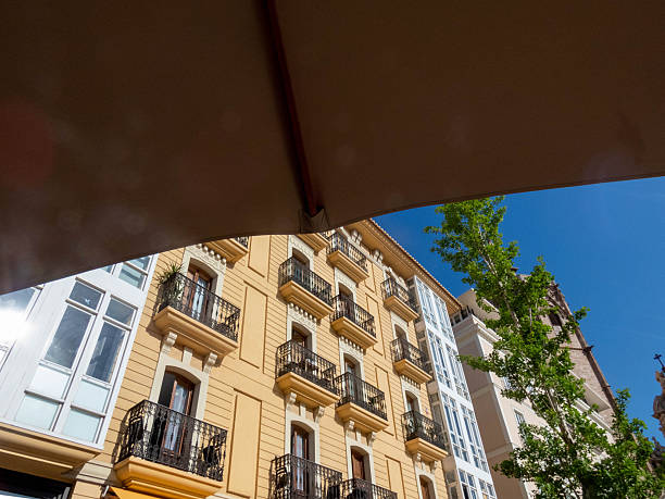 istock Enjoying the cityscape from under a parasol on a sunny day 2203271983