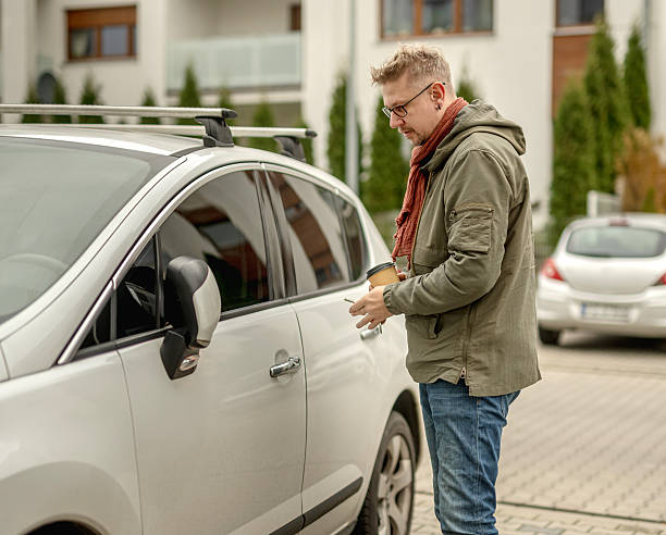 istock Young Attractive Man Parking A Car On A Street 2203272754