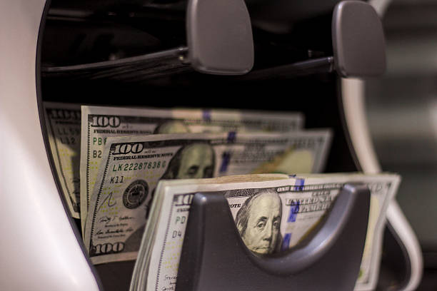 istock US dollars in money counter machine 2203273273