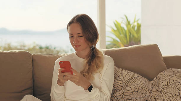 istock Young woman using mobile phone for chatting in social networks 2203273838