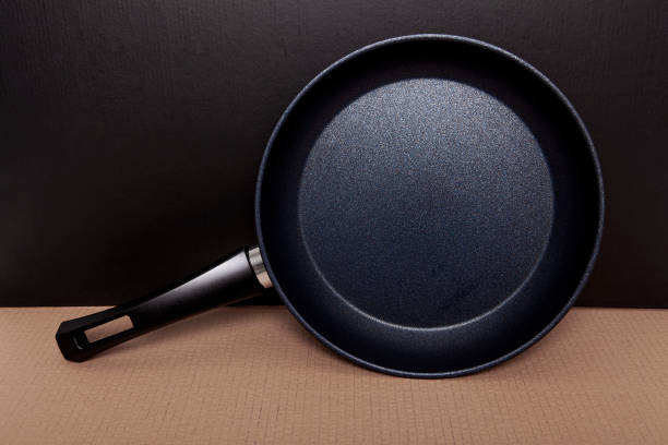 istock New black granite pan on gray background. 2203276152